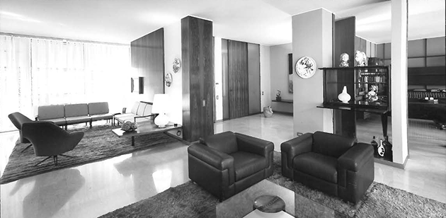 The living area in Osvaldo Borsani's apartment on Via Montenapoleone showing the present P32 model armchair and E22 shelving system CREDIT: Archivio Osvaldo Borsani / Pietro Carrieri
